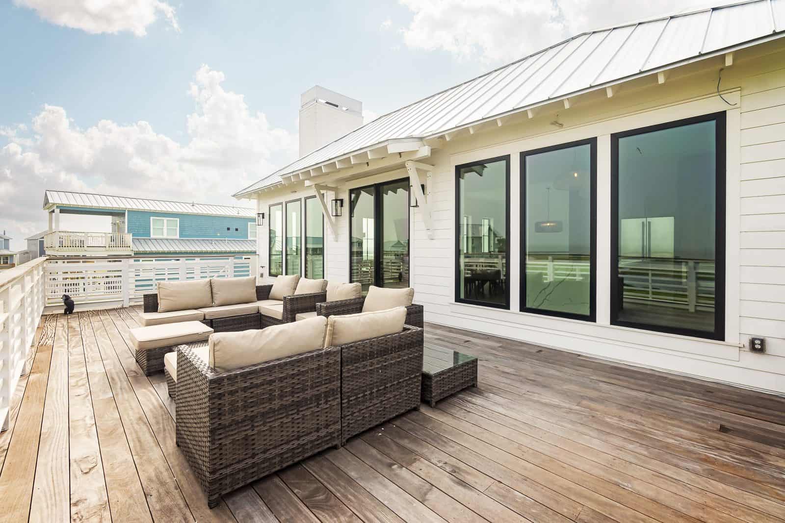 Standing-seam metal roof over a covered upper deck on a custom coastal home, showing the seam profile and roof assembly