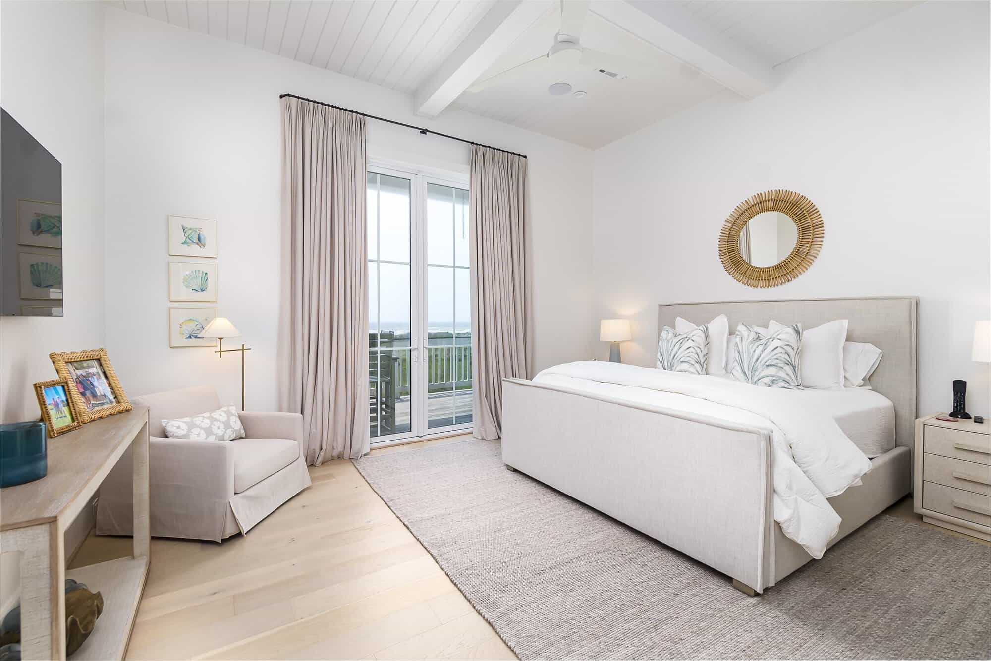 Primary bedroom with French doors to an ocean-view balcony in a Kai Custom Homes build in Pointe West, Galveston